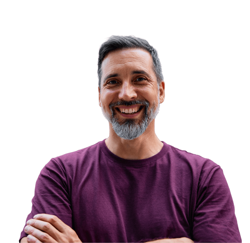 Smiling man with greying hair and a beard, arms folded, in a plum t-shirt